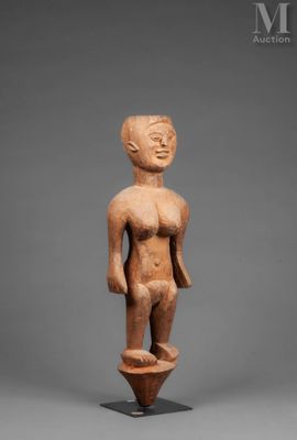 a small statue of a man standing on top of a pedestal