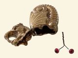 a silver object with a red berry in it