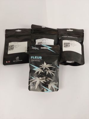 three bags of fleur tea sitting on top of a white table