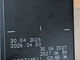 a person holding up a black card with numbers on it