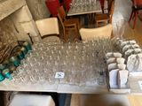 many empty wine glasses on a table in a restaurant