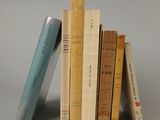 several books are stacked on top of each other on a table