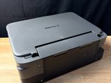 a black printer sitting on top of a wooden table