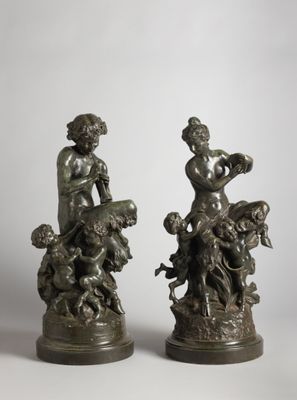 pair of bronze figurines of a boy and a girl with a dog
