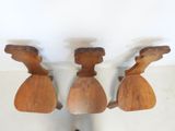 three pieces of wood sitting on top of a table next to each other