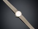 a close up of a watch on a black surface