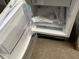 a refrigerator that is open and sitting on the floor