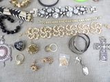 many different types of bracelets and rings laid out on a table
