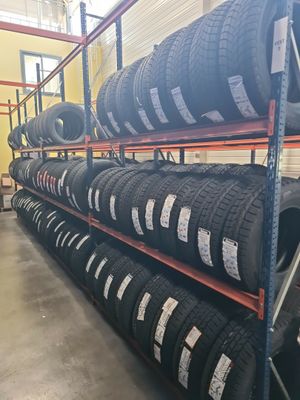 tires are stacked up on a rack in a warehouse