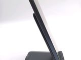 a cell phone on a stand on a white surface