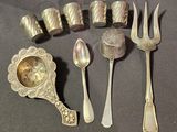 a lot of silver spoons, forks, and a clock