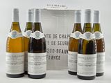 three bottles of wine are sitting in front of a box of wine