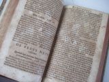an old book that is open on a table