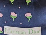 a blue shirt with pink flowers on it with a name tag