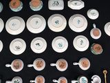 many different types of tea cups and saucers on the table
