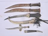 five different types of knives on a white surface