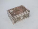 an antique silver box with a picture of a man and a woman on it