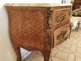 a small chest of drawers in the corner of a room