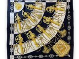 a black and white scarf with gold and silver decorations
