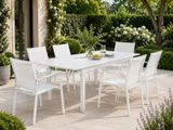 a white table and chairs on the patio
