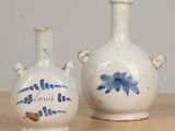 two vases that are sitting on a table