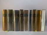 several books are lined up in a row on a table