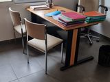 a desk with two chairs and a map on the wall