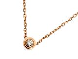 a close up of a necklace with a diamond on a chain
