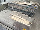 many pieces of wood sitting on the floor in a room