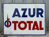 a sign that says azur total on the side of a building