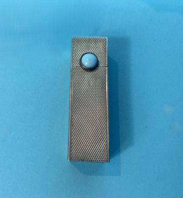 a lighter that is sitting on a blue surface