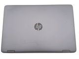 the laptop is open on a white surface with a logo on the screen