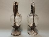 pair of antique silver plated glass vases sitting on a table