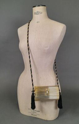 the gold and black purse is on a mannequin mannequin