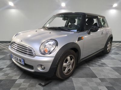 a small silver car parked on a checkered floor