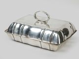 silver plated butter dish with a ring on top of it