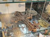 a glass display case with a cross and other religious items