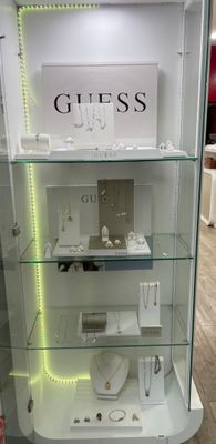 a glass display case with a lot of jewelry on it