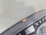 a close up of a black and white vase with a sun design on it