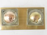 two gold colored candles sitting on top of a gold plate
