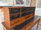 a wooden table with a black drawer on top of it