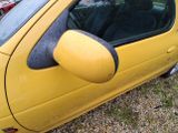 a yellow car that is parked on the side of the road