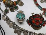 many different necklaces and bracelets that are on a table