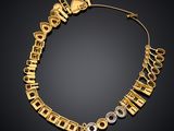 an image of a gold necklace with various symbols on it