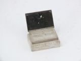 a small silver box with a mirror on it