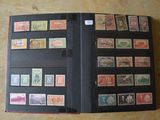 un dossier noir sur lequel sont collés de nombreux timbres