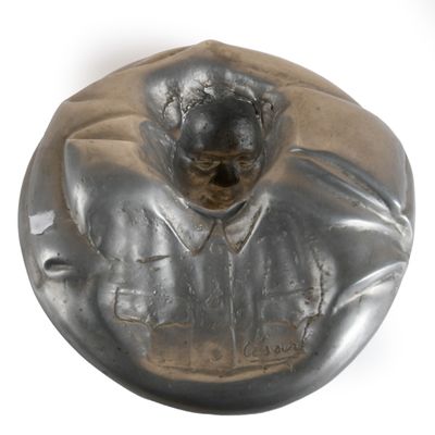 a statue of a man in a suit on a plate