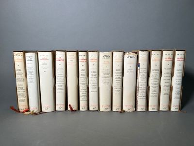 several books are lined up in a row on a gray surface