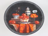 a plate with a bowl of tomatoes and oranges on it