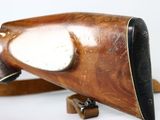 a wooden object with a metal handle on a white surface